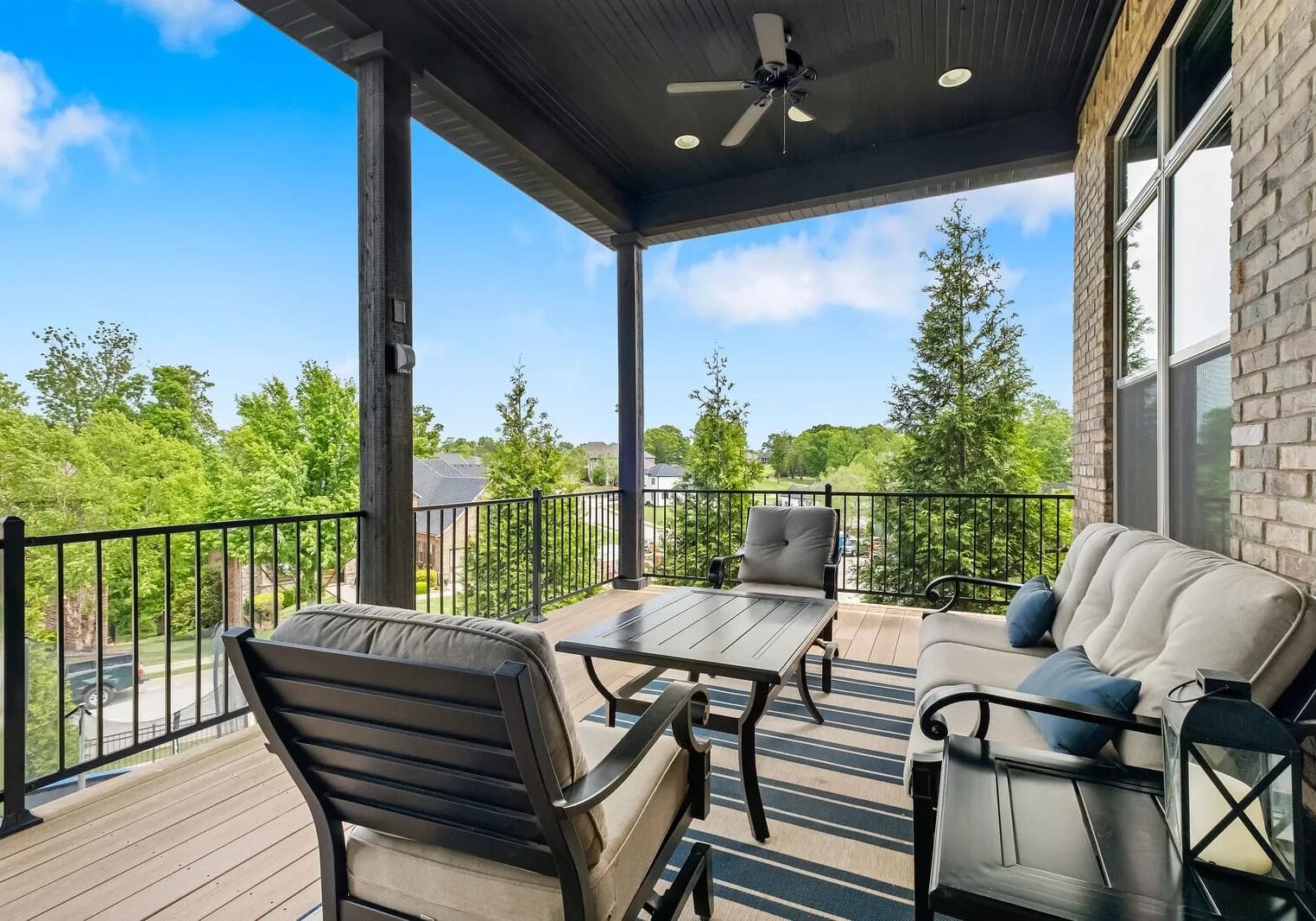 A patio with furniture and trees in the background.