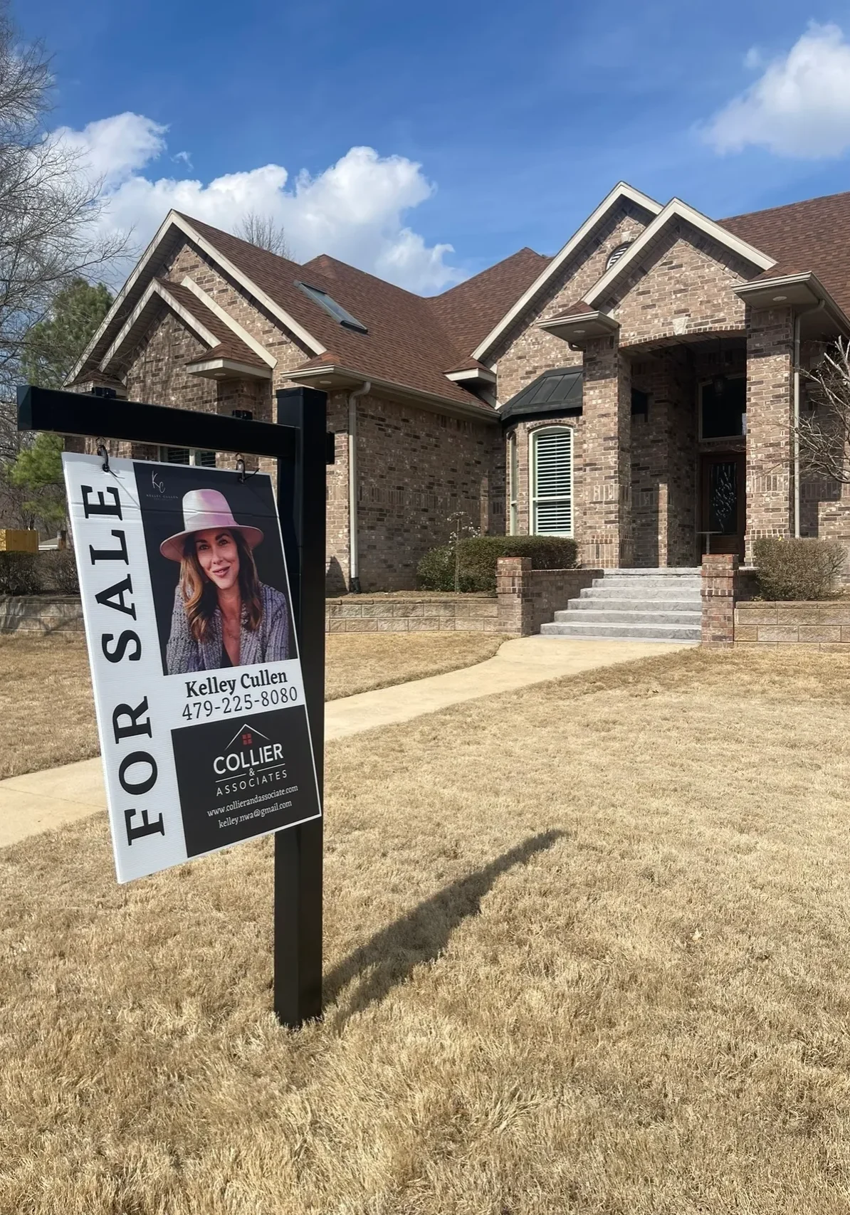A for sale sign in front of a house.